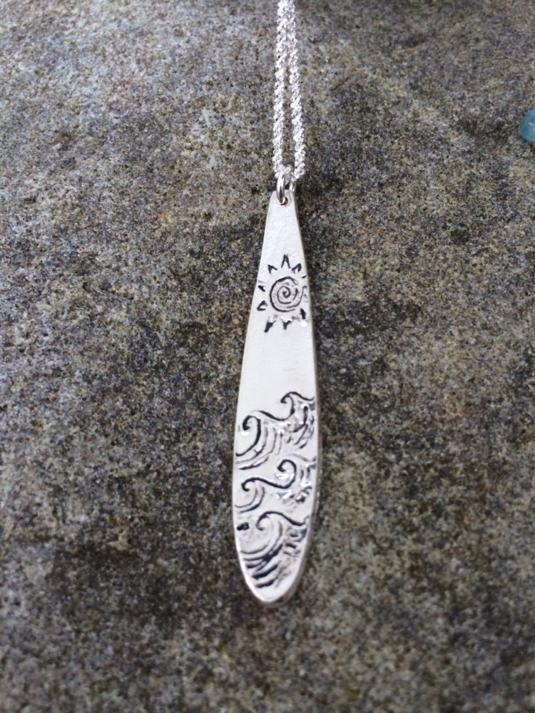 Hand etched fine silver surfboard pendant, sun and sea design.