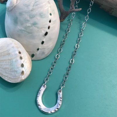 handcrafted Horseshoe is on a 18 1/2 inch textured Sterling silver chain.