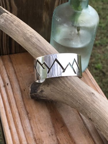 This hand sawed Mountain skyline is precisely pierced out of Sterling Silver and shaped for the Slope Lover.