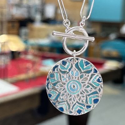 Sterling silver starburst and turquoise round locket necklace