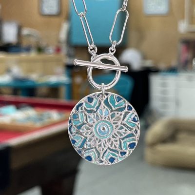 Sterling silver starburst and turquoise round locket necklace